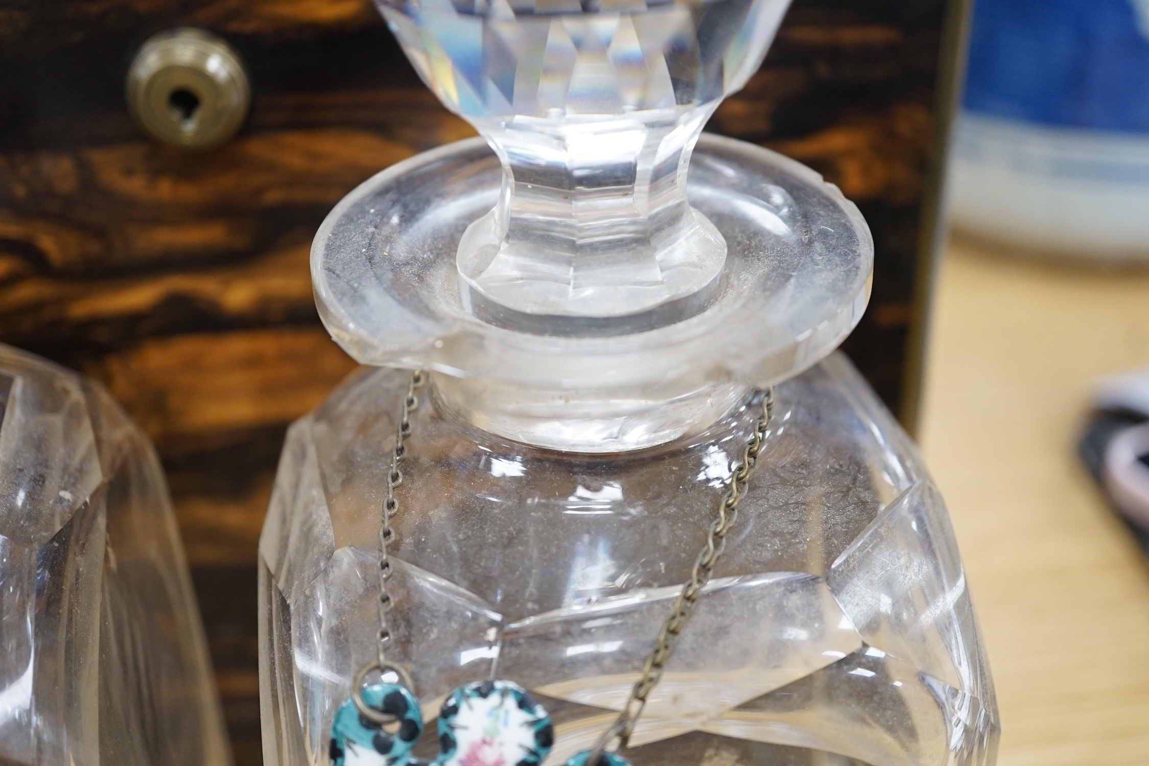 A Victorian coromandel four bottle decanter box with Bramah lock, three silver ‘hunting’ spirit labels and another enamelled, height of box 30cm